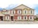 Modern two-story townhome with neutral color palette and guest parking at 7525 Sunflower Cir, Kissimmee, FL 34747