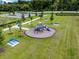 Aerial view of a playground with playset, picnic tables, and ample green space at 3430 Bowthorpe Ln, Apopka, FL 32703