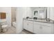 Double vanity bathroom with granite countertop and shower at 33239 Country House Dr, Sorrento, FL 32776