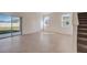 Bright living room with sliding glass doors to backyard at 33239 Country House Dr, Sorrento, FL 32776