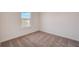 Well-lit bedroom featuring neutral walls and carpet at 33239 Country House Dr, Sorrento, FL 32776