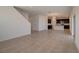 Open living room with tile floors and stairs to second floor at 33239 Country House Dr, Sorrento, FL 32776