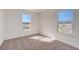 Bright bedroom with neutral carpeting and two large windows at 33239 Country House Dr, Sorrento, FL 32776