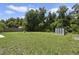 Large backyard with shed and mature trees at 342 W De Carlo Dr, Deltona, FL 32725