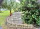 Small patio area with surrounding landscaping at 5610 King James Ave, Leesburg, FL 34748
