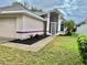 House exterior showcasing the front entrance and landscaping at 5610 King James Ave, Leesburg, FL 34748