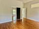 Bedroom with wood laminate flooring and mirrored closet doors at 5610 King James Ave, Leesburg, FL 34748