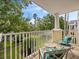 Private balcony with two chairs and a small table overlooking a courtyard at 7502 Seven Eagles Way, Reunion, FL 34747