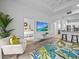 Open living room with large TV, comfortable seating, and access to bedroom at 7502 Seven Eagles Way, Reunion, FL 34747
