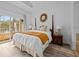 Spacious main bedroom with king bed, private balcony access, and en-suite bathroom at 7502 Seven Eagles Way, Reunion, FL 34747