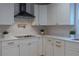 Modern kitchen with white cabinets, quartz countertops, and a gas cooktop at 17 N Shine Ave, Orlando, FL 32801