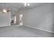 Bright living room with high ceilings, ceiling fan, and neutral color palette at 1042 Twisted Branch Ln, St Cloud, FL 34771