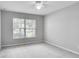 Spacious bedroom with large window, ceiling fan and neutral wall paint at 1042 Twisted Branch Ln, St Cloud, FL 34771