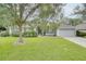 Gray house with a two-car garage and lush green lawn at 1042 Twisted Branch Ln, St Cloud, FL 34771