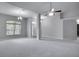 Open concept living room with a view of the kitchen and entryway at 1042 Twisted Branch Ln, St Cloud, FL 34771