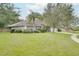 One-story house with mature landscaping and a paved driveway at 1042 Twisted Branch Ln, St Cloud, FL 34771