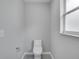 Clean bathroom with modern toilet and window at 1042 Twisted Branch Ln, St Cloud, FL 34771