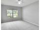 Spacious bedroom with large window, ceiling fan and neutral wall paint at 1042 Twisted Branch Ln, St Cloud, FL 34771