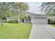 Single-story home with gray siding and a two-car garage at 1042 Twisted Branch Ln, St Cloud, FL 34771