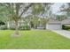 Gray house with a two-car garage and lush green lawn at 1042 Twisted Branch Ln, St Cloud, FL 34771