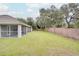 Expansive grassy backyard with screened porch at 1042 Twisted Branch Ln, St Cloud, FL 34771