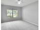 Spacious bedroom with large window, ceiling fan and neutral wall paint at 1042 Twisted Branch Ln, St Cloud, FL 34771