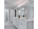 Modern double vanity bathroom with a large mirror and separate shower at 1042 Twisted Branch Ln, St Cloud, FL 34771