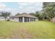 Large backyard with screened porch and brick wall at 1042 Twisted Branch Ln, St Cloud, FL 34771