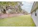 Landscaped backyard with brick wall and lush lawn at 1042 Twisted Branch Ln, St Cloud, FL 34771