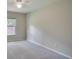 Spacious bedroom with ceiling fan, window, and neutral-colored carpet at 1042 Twisted Branch Ln, St Cloud, FL 34771