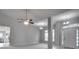 Open concept living room with a view of the kitchen and entryway at 1042 Twisted Branch Ln, St Cloud, FL 34771