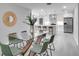 Modern glass dining table with seating for six at 1042 Twisted Branch Ln, St Cloud, FL 34771