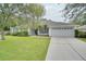 House exterior with driveway and landscaping at 1042 Twisted Branch Ln, St Cloud, FL 34771