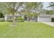Gray house with a two-car garage and lush green lawn at 1042 Twisted Branch Ln, St Cloud, FL 34771