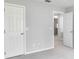 Bedroom with carpet, white doors and access to another room at 1042 Twisted Branch Ln, St Cloud, FL 34771