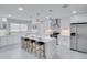 Modern white kitchen with large island, stainless steel appliances, and ample counter space at 1042 Twisted Branch Ln, St Cloud, FL 34771