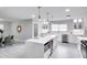 Bright kitchen featuring a large island, white cabinetry, and stainless steel appliances at 1042 Twisted Branch Ln, St Cloud, FL 34771