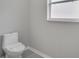 Simple bathroom with toilet and window at 1042 Twisted Branch Ln, Saint Cloud, FL 34771