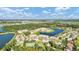 Aerial view of a community with lake, tennis court, and homes at 3663 Circle Hook St, Kissimmee, FL 34746
