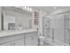 Main bathroom with double vanity, large mirror and a walk in shower at 3663 Circle Hook St, Kissimmee, FL 34746