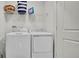 Bright laundry room with washer and dryer, shelving and storage at 3663 Circle Hook St, Kissimmee, FL 34746