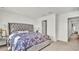 Spacious bedroom with a tufted headboard and patterned bedding at 3663 Circle Hook St, Kissimmee, FL 34746