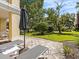 Patio with lounge chairs and umbrella, overlooking green space at 7502 Seven Eagles Way, Reunion, FL 34747