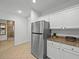 Kitchen with stainless steel refrigerator and granite countertops at 7502 Seven Eagles Way, Reunion, FL 34747