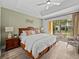 Main bedroom with king bed and access to patio at 7502 Seven Eagles Way, Reunion, FL 34747