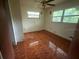 Simple bedroom with tiled floors and window at 1472 Marvin C Zanders Ave, Apopka, FL 32703