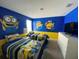 Minion themed bedroom with twin beds and TV at 1548 Moon Valley Dr, Davenport, FL 33896