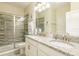 Bathroom with double sinks, granite countertop, and a walk-in shower at 1548 Moon Valley Dr, Davenport, FL 33896