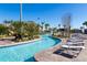 Lazy river with lounge chairs and tropical landscaping at 1548 Moon Valley Dr, Davenport, FL 33896