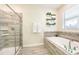 Modern bathroom with walk-in shower and soaking tub at 1548 Moon Valley Dr, Davenport, FL 33896